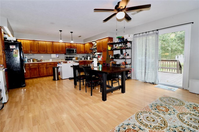 dining room with ceiling fan and light wood-type flooring