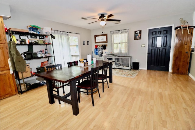 dining area with light hardwood / wood-style floors and ceiling fan