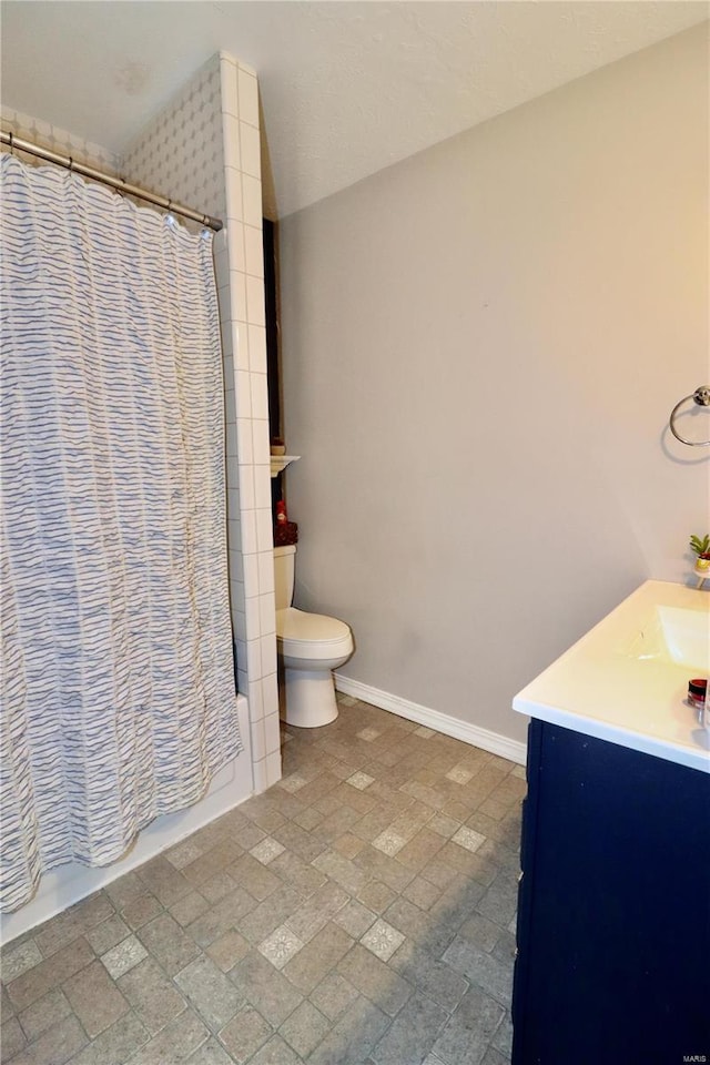 bathroom featuring tile patterned floors, vanity, and toilet