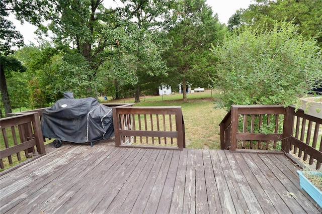 wooden deck with grilling area and a lawn