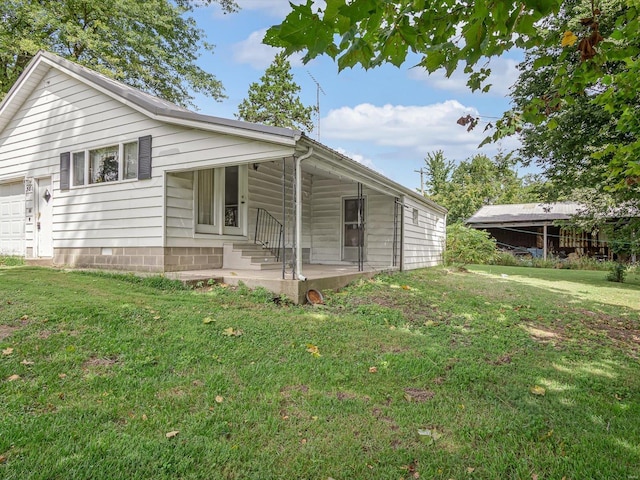 rear view of house with a yard and covered porch