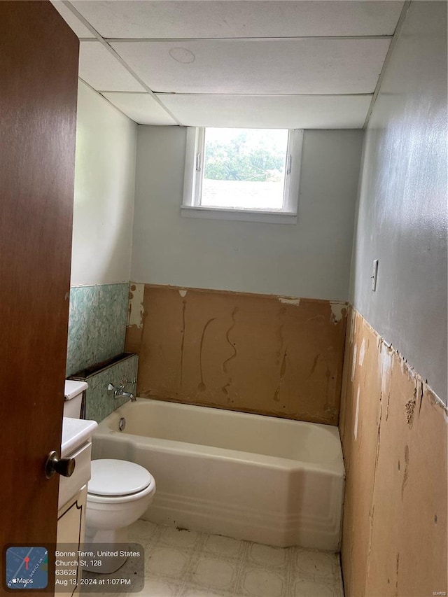 bathroom featuring vanity, a bathtub, tile patterned flooring, and toilet