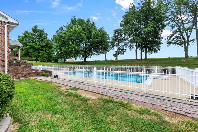 view of pool with a yard