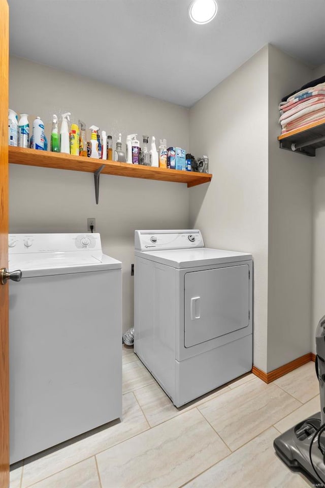 laundry area with light tile patterned flooring and washing machine and clothes dryer