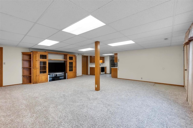 basement featuring light colored carpet and a drop ceiling