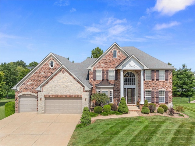 view of front of property featuring a garage and a front lawn