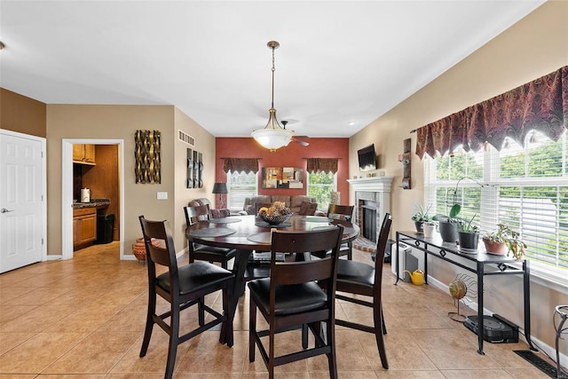 dining area with ceiling fan and light tile patterned floors