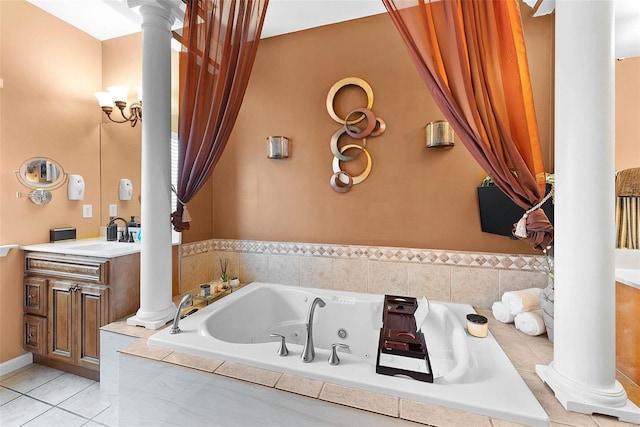 bathroom featuring vanity, tile patterned flooring, decorative columns, and tiled bath