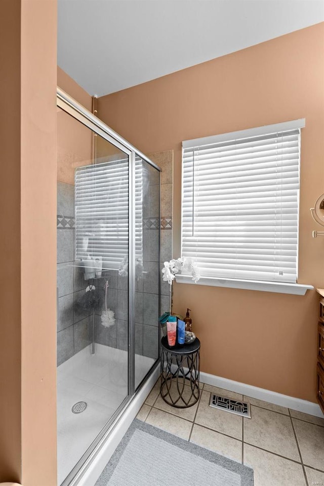 bathroom with vanity, tile patterned floors, and walk in shower