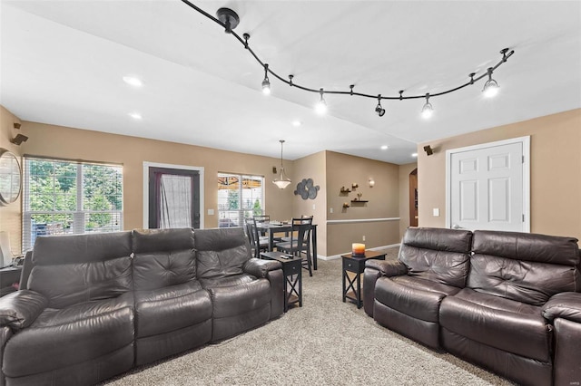 living room featuring light carpet and rail lighting