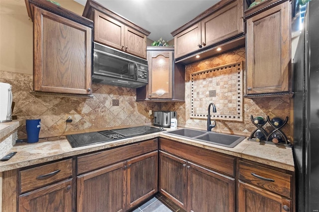 kitchen with black appliances, sink, tile patterned floors, and tasteful backsplash