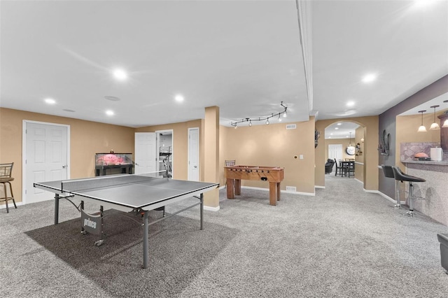 recreation room with track lighting and light carpet