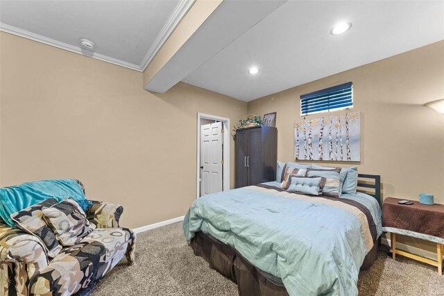 carpeted bedroom featuring crown molding