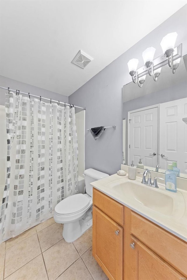 bathroom featuring tile patterned floors, toilet, and vanity