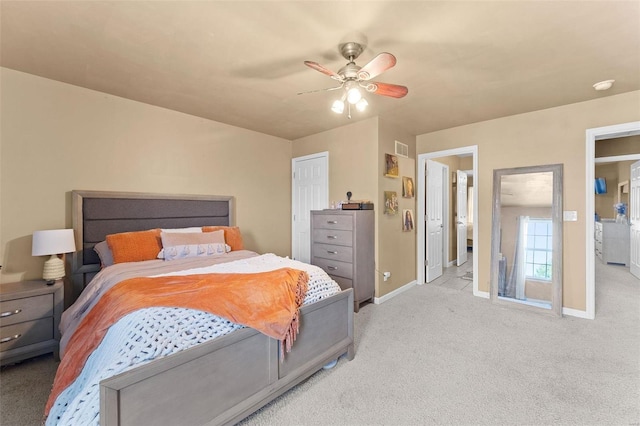 carpeted bedroom with ceiling fan and ensuite bath