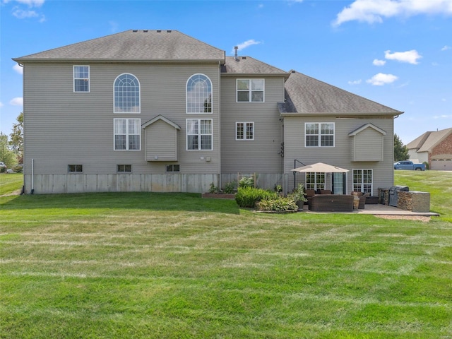 rear view of property with a yard and a patio