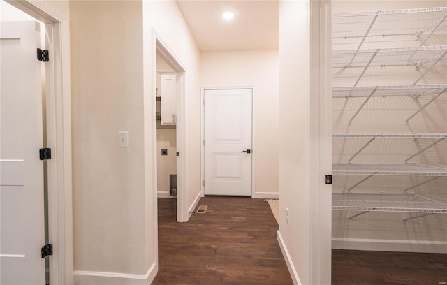 corridor with dark hardwood / wood-style floors