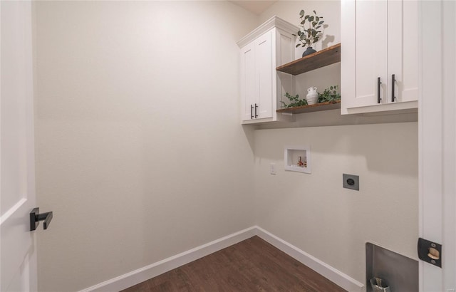 clothes washing area with dark wood-type flooring, hookup for an electric dryer, hookup for a washing machine, and cabinets