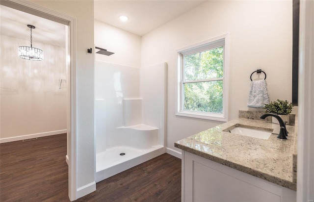 bathroom with a shower, wood-type flooring, vanity, and toilet