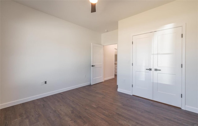 unfurnished bedroom with dark wood-type flooring, a closet, and ceiling fan