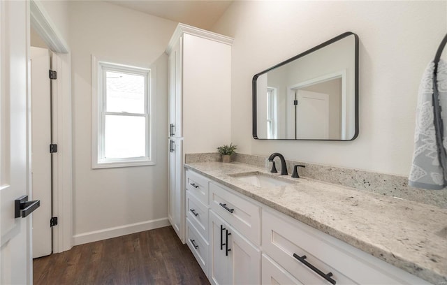 bathroom with hardwood / wood-style flooring and vanity