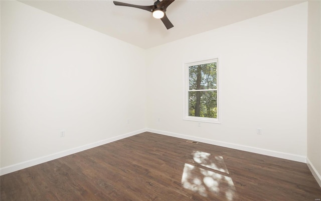 empty room with ceiling fan and dark hardwood / wood-style floors