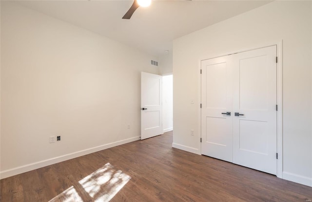 unfurnished bedroom with ceiling fan, a closet, and dark hardwood / wood-style floors