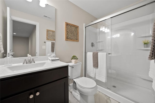 bathroom with tile patterned flooring, a shower with shower door, vanity, and toilet