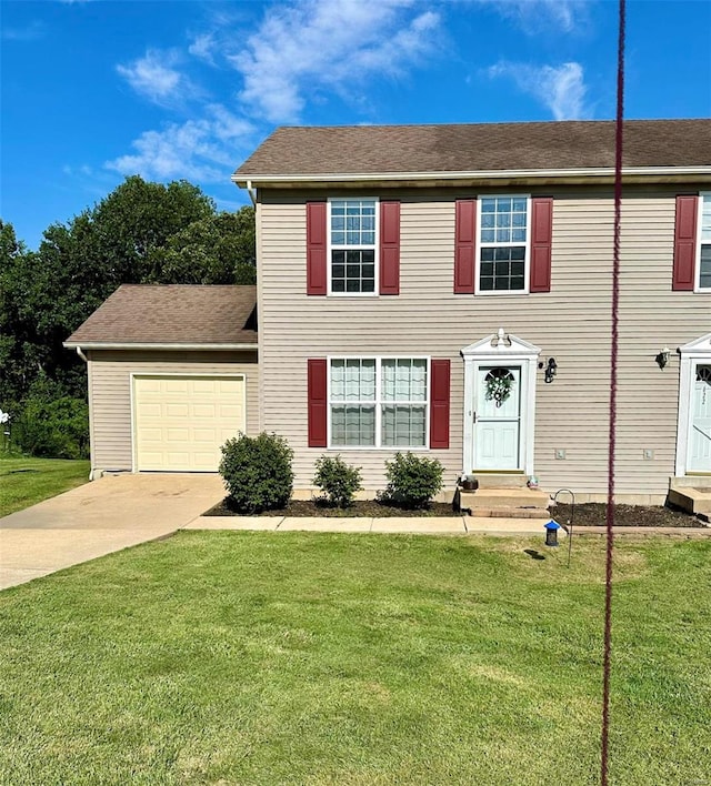 view of front of home featuring a front lawn and a garage