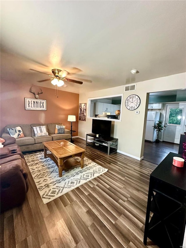 living room with ceiling fan and hardwood / wood-style flooring