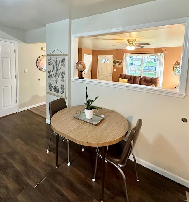 dining space featuring ceiling fan and dark hardwood / wood-style floors