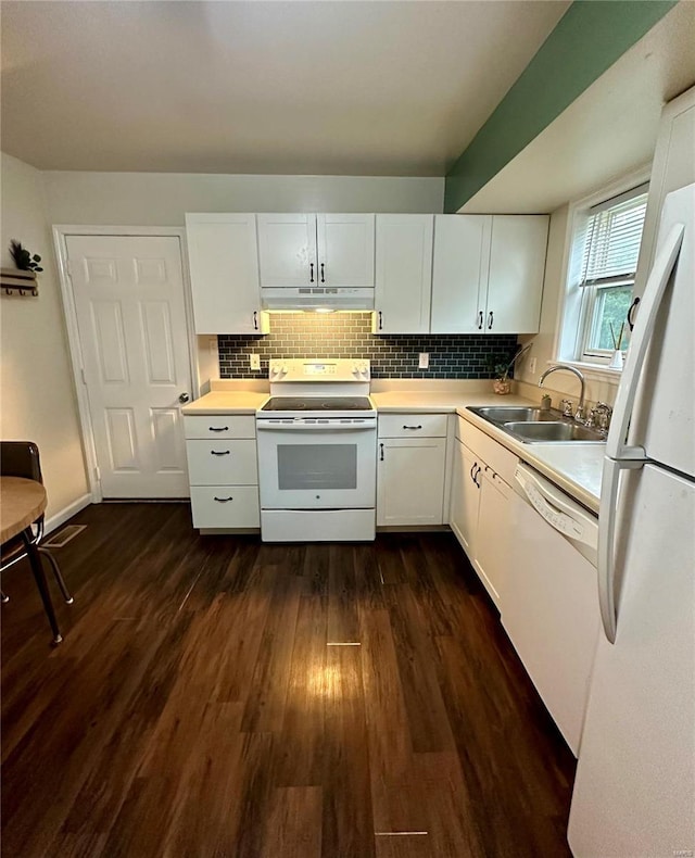 kitchen with dark hardwood / wood-style floors, backsplash, white cabinetry, sink, and white appliances