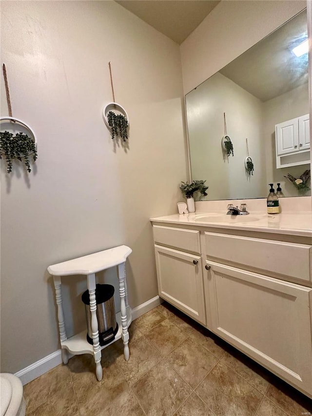 bathroom featuring toilet, tile patterned flooring, and vanity