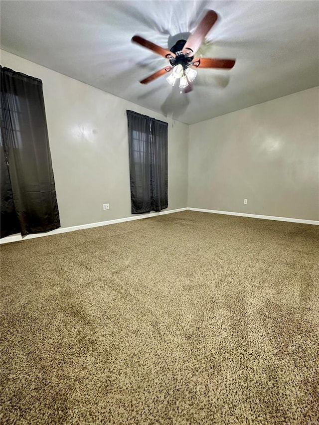 unfurnished room with ceiling fan and carpet