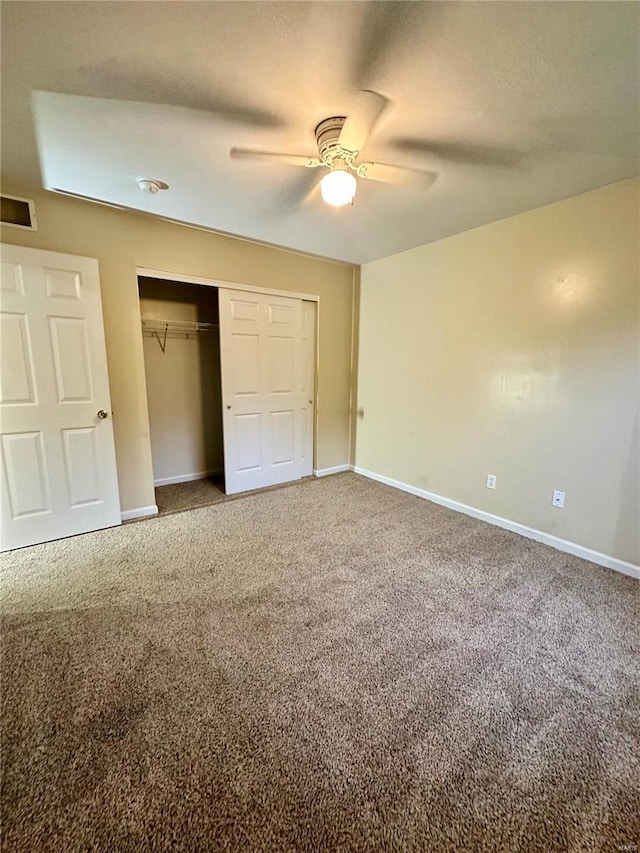 unfurnished bedroom with carpet floors, ceiling fan, and a closet