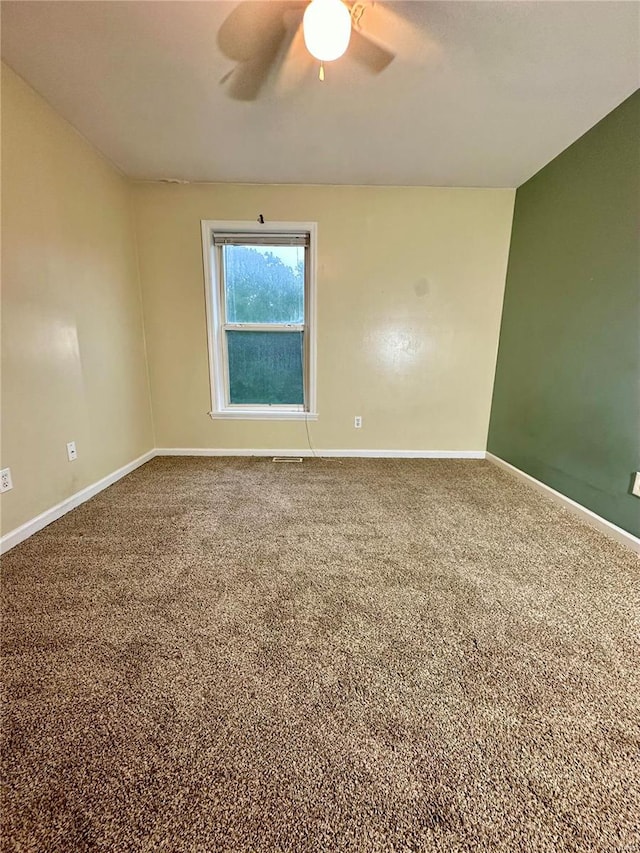 unfurnished room with carpet and ceiling fan