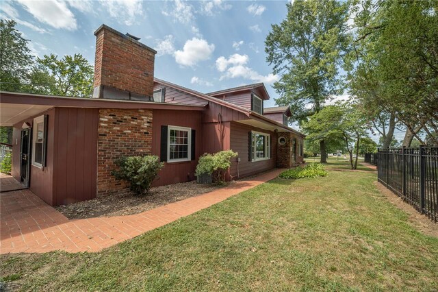 back of house with a yard