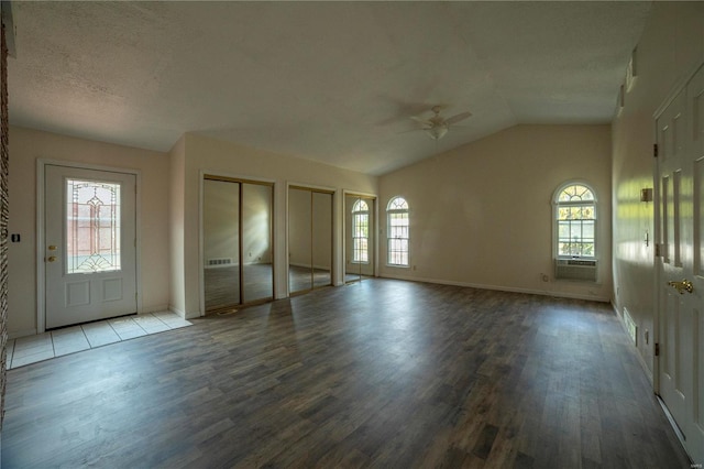 entrance foyer featuring lofted ceiling, ceiling fan, a textured ceiling, and wood finished floors