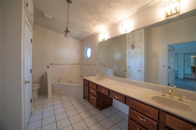 bathroom featuring a garden tub, double vanity, toilet, a sink, and a textured ceiling