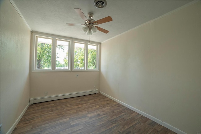 empty room with ornamental molding, a baseboard radiator, visible vents, and wood finished floors