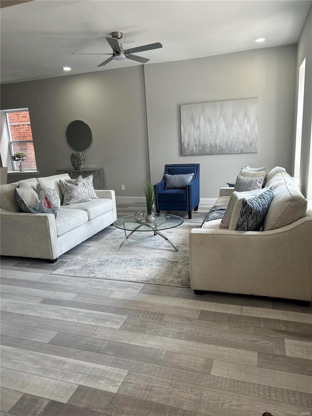 living room featuring ceiling fan and light hardwood / wood-style floors