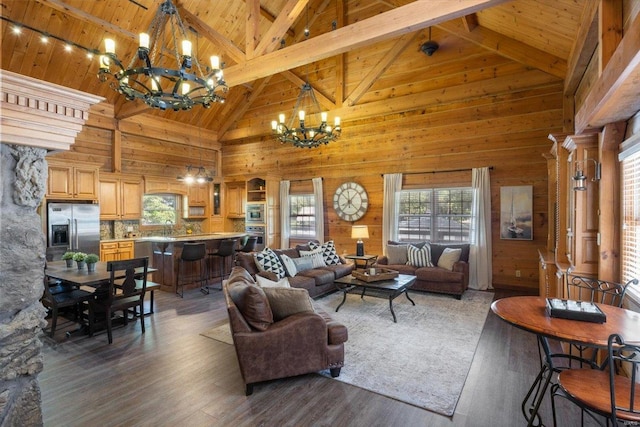 living room featuring a notable chandelier, high vaulted ceiling, wooden walls, hardwood / wood-style flooring, and beamed ceiling