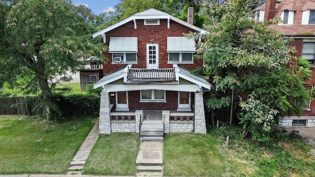 view of front of property with a front lawn and a balcony