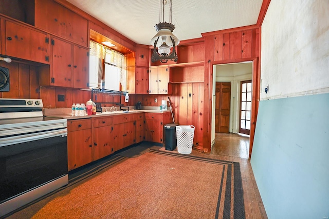 kitchen with stainless steel electric stove, sink, and dark wood-type flooring