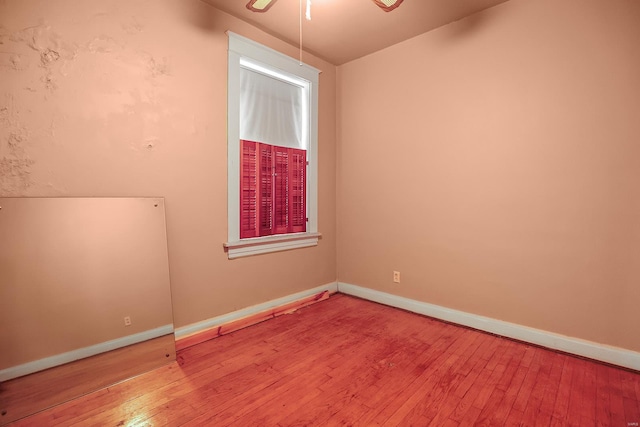 unfurnished room with ceiling fan and hardwood / wood-style flooring