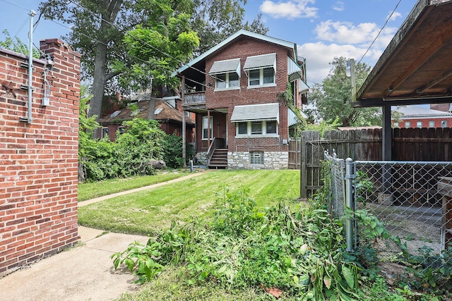 rear view of property with a lawn