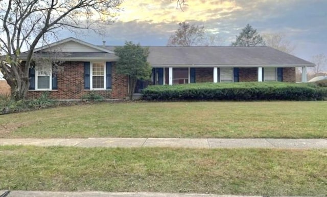 ranch-style house featuring a yard