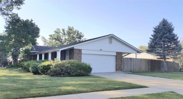 ranch-style house with a garage and a front yard