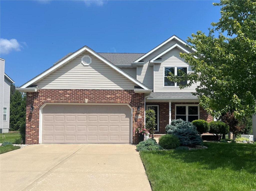 view of front of home with a garage and a front yard