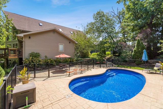 view of swimming pool with a patio area, fence, and a fenced in pool